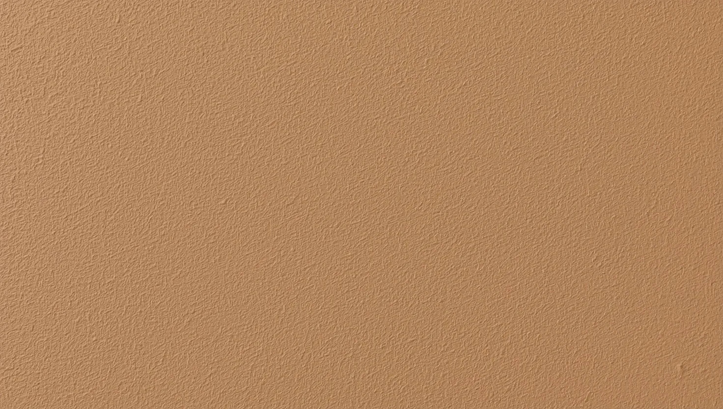 Parete rifinita a intonaco d'argilla con texture e tonalita terrosa